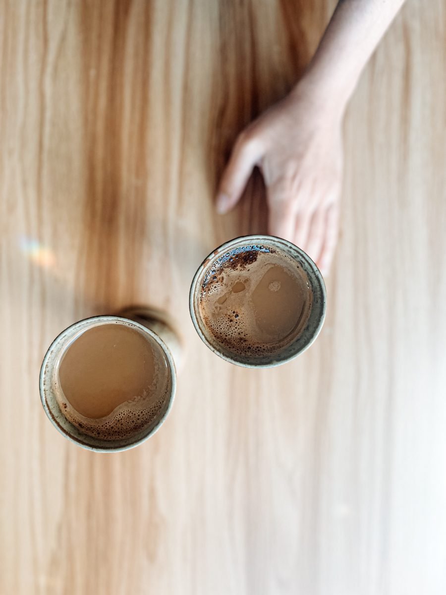 Two cups with Turkish Coffee and Milk, Star Anise and Cinnamon in them.
